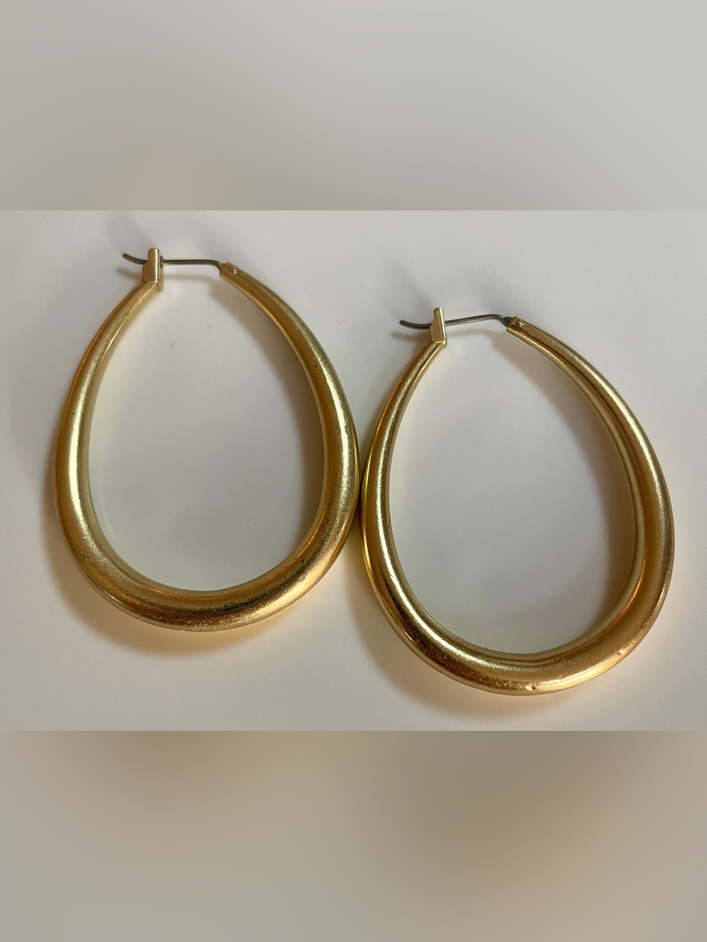 Gold toned hoop earrings.